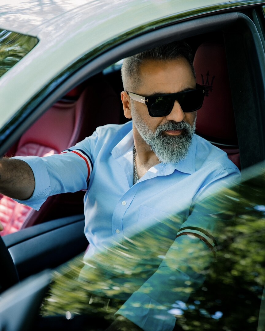 Peter Torkan wearing sunglasses in a car
